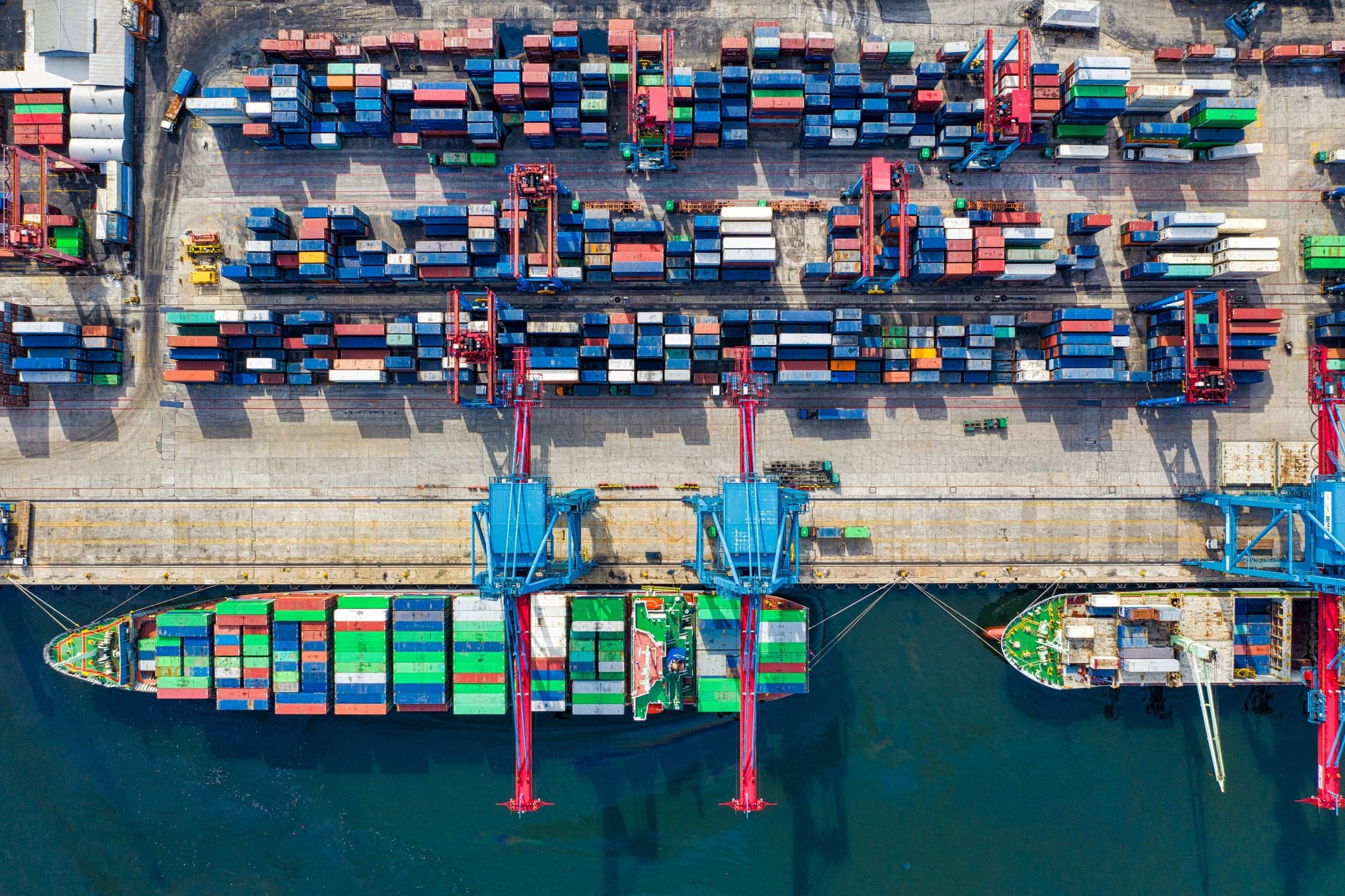 Aerial photograph of colorful shipping containers at a port, symbolizing cross-border commerce